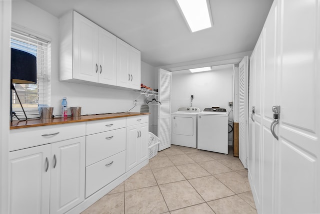 washroom with washer and dryer and light tile patterned flooring