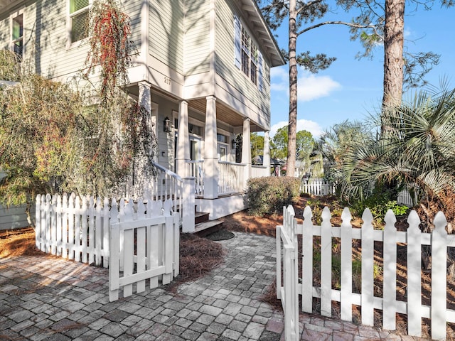 view of side of property with a porch