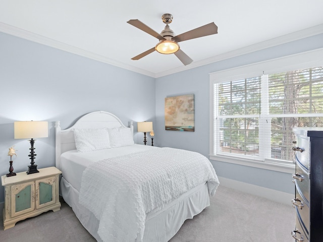 carpeted bedroom with multiple windows, ornamental molding, and ceiling fan