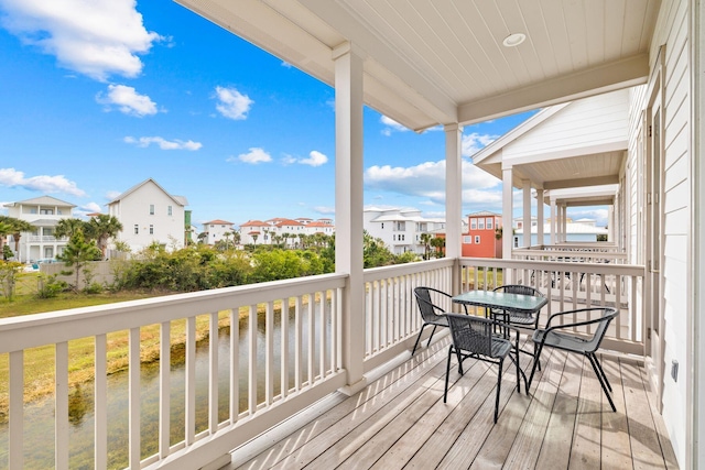 wooden deck featuring a water view