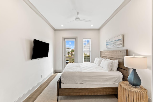 bedroom featuring hardwood / wood-style flooring, ceiling fan, and ornamental molding