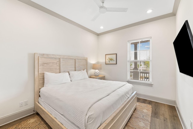 bedroom with ceiling fan, wood-type flooring, and crown molding