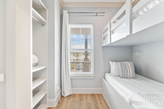 bedroom featuring multiple windows and light hardwood / wood-style flooring