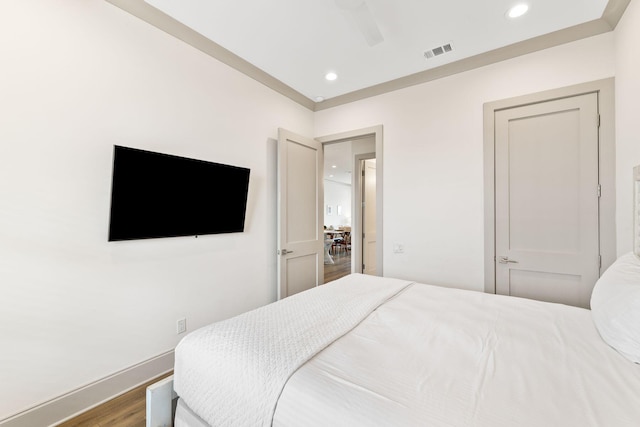 bedroom with hardwood / wood-style floors and ceiling fan