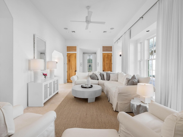 living room featuring ceiling fan and light carpet