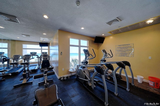 exercise room featuring a textured ceiling