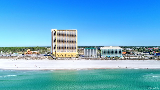 drone / aerial view with a water view and a view of the beach