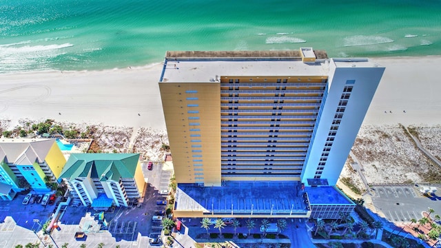 exterior space with a water view and a beach view