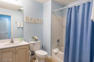 full bathroom featuring shower / tub combo, vanity, and toilet