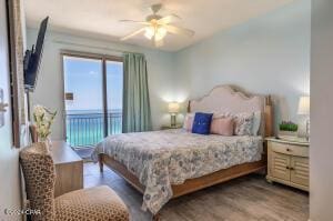 bedroom featuring access to exterior, ceiling fan, and hardwood / wood-style floors