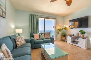 tiled living room featuring ceiling fan