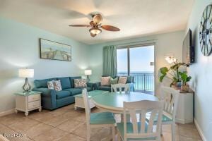 living room with ceiling fan and light tile patterned floors