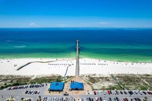 bird's eye view with a water view and a beach view