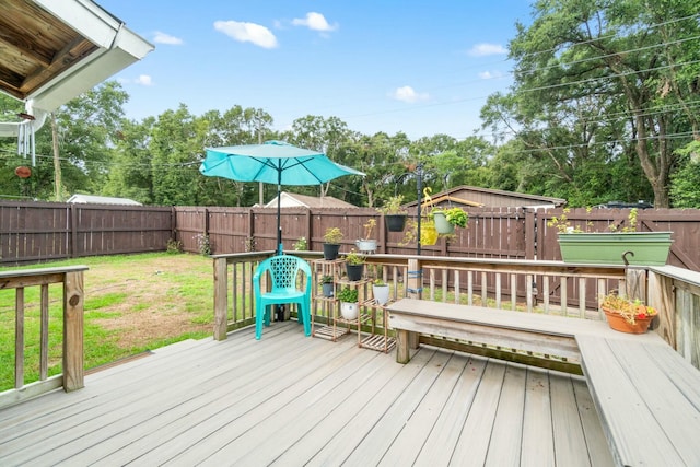 wooden terrace with a yard