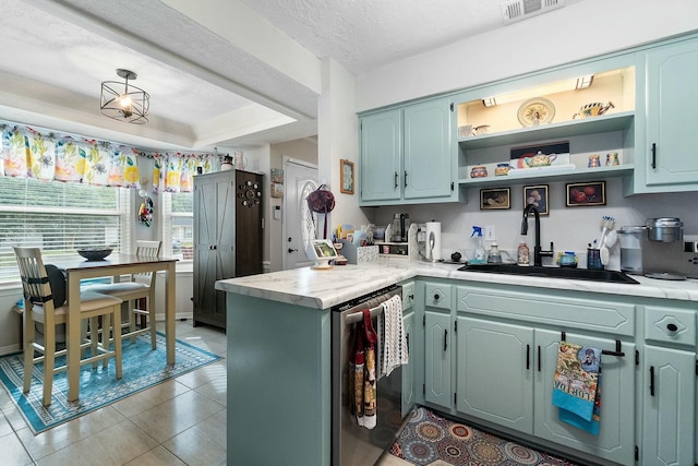 kitchen with dishwasher, sink, kitchen peninsula, a textured ceiling, and a tray ceiling