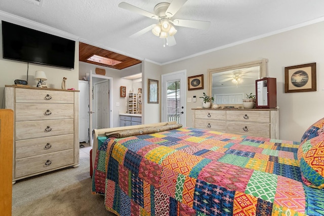 carpeted bedroom with ceiling fan, ornamental molding, and a textured ceiling