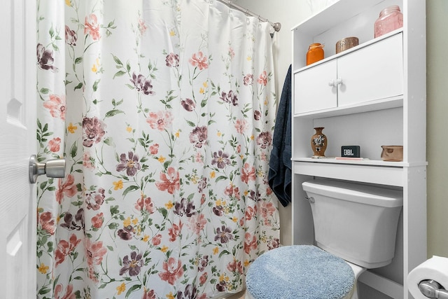 bathroom featuring toilet and walk in shower