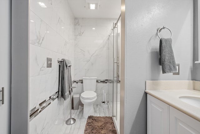 bathroom featuring vanity, toilet, and an enclosed shower