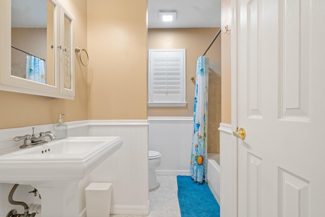 full bathroom with shower / bath combination with curtain, toilet, and sink