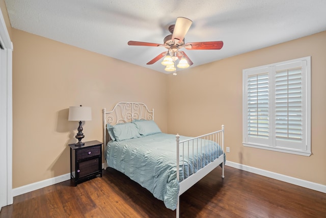 bedroom featuring ceiling fan and dark wood-type flooring