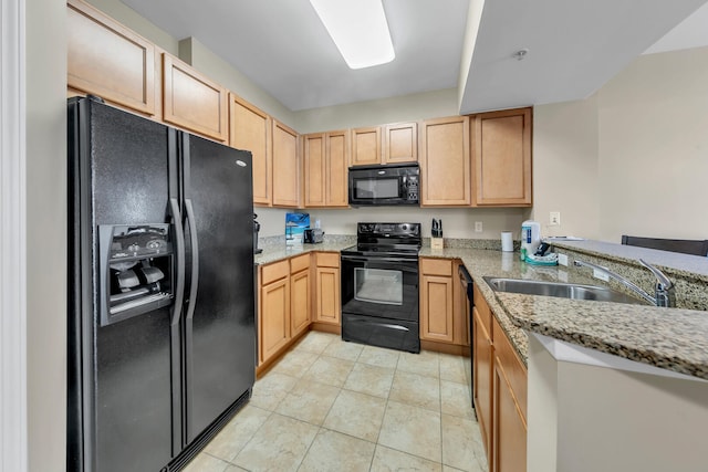 kitchen with light brown cabinetry, light stone counters, sink, and black appliances