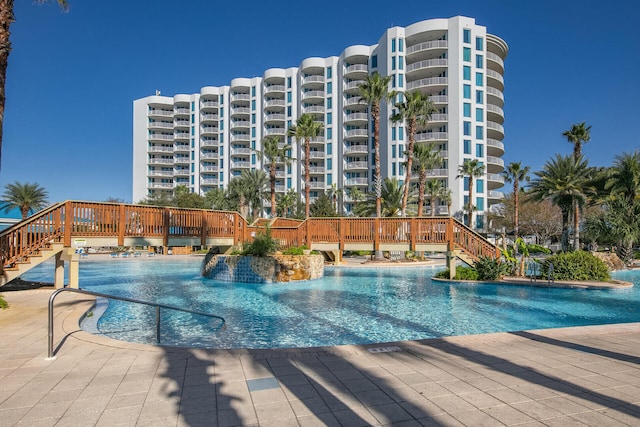 view of swimming pool with pool water feature