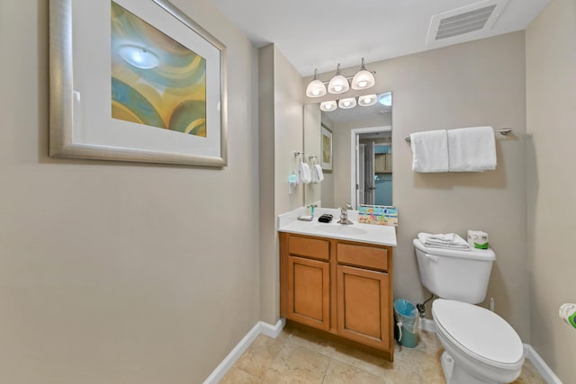 bathroom with tile patterned flooring, vanity, and toilet