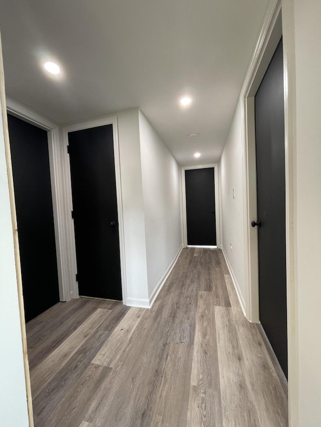 corridor with light hardwood / wood-style floors