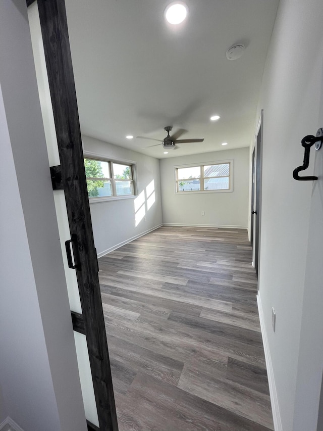 empty room with wood-type flooring and ceiling fan