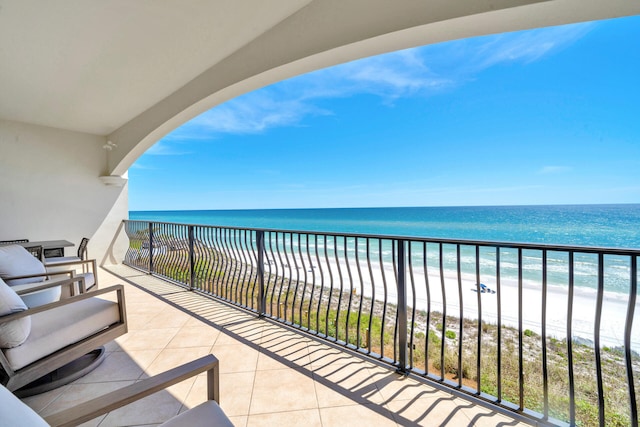 balcony with a beach view and a water view