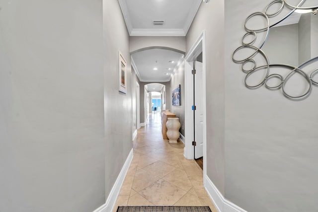 corridor with ornamental molding and light tile patterned floors