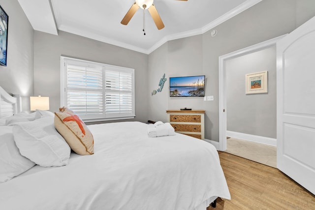 bedroom featuring ceiling fan, light hardwood / wood-style floors, and ornamental molding