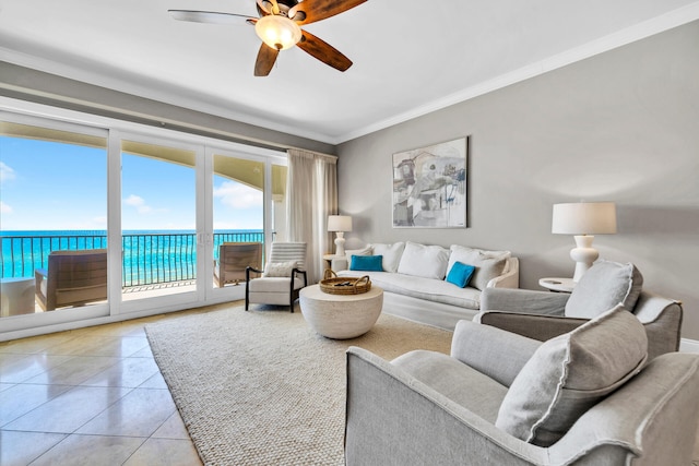 living room featuring a water view, ceiling fan, ornamental molding, and light tile patterned flooring