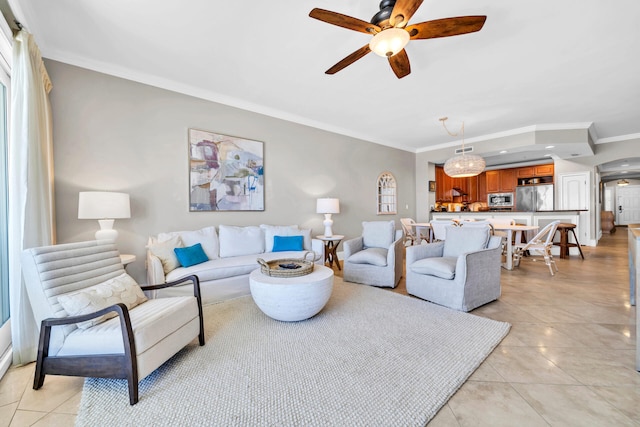 living room with ceiling fan, light tile patterned floors, and ornamental molding