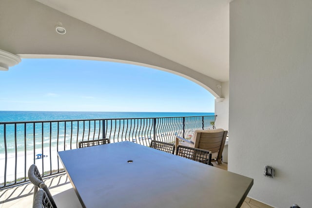 balcony featuring a water view and a view of the beach