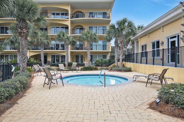 view of pool with a hot tub