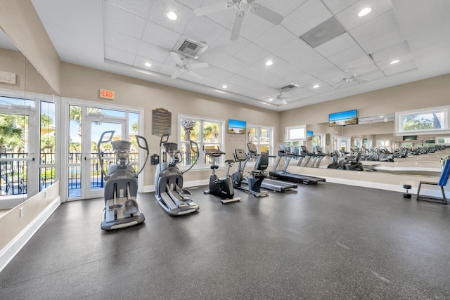 exercise room with a paneled ceiling and ceiling fan