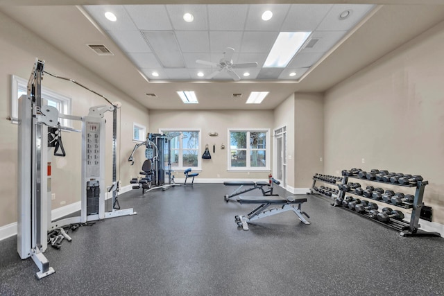 workout area with a paneled ceiling and ceiling fan