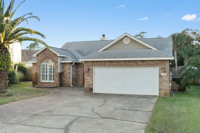 ranch-style home featuring a garage and a front yard