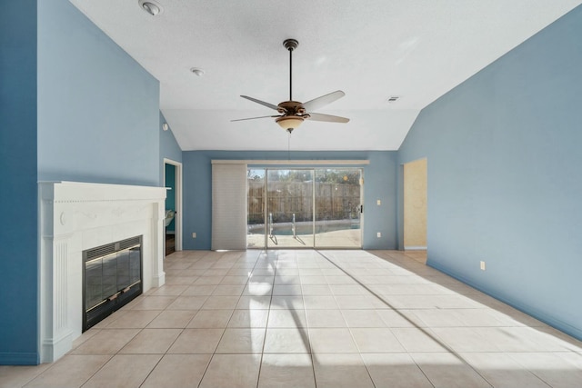 unfurnished living room with ceiling fan, light tile patterned flooring, and lofted ceiling