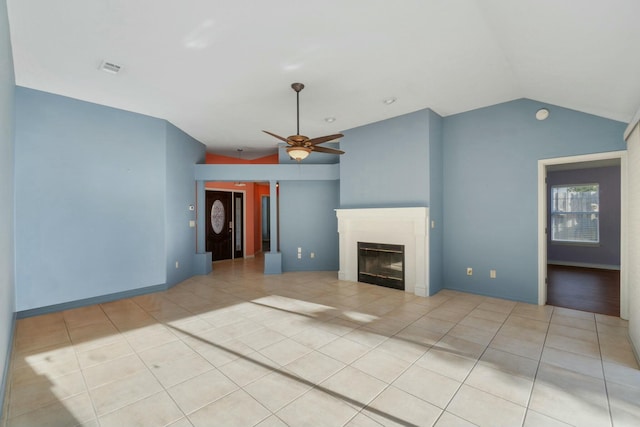 unfurnished living room featuring ceiling fan, light tile patterned floors, and vaulted ceiling