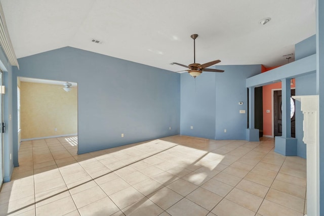 empty room with light tile patterned floors, vaulted ceiling, and ceiling fan