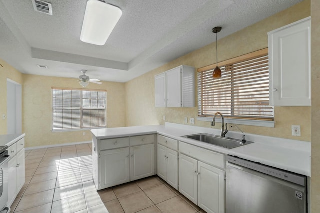 kitchen with dishwasher, white cabinets, sink, decorative light fixtures, and kitchen peninsula