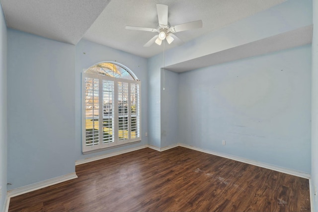 unfurnished room featuring a textured ceiling, ceiling fan, and dark wood-type flooring