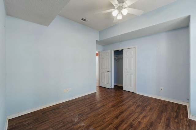 empty room with dark hardwood / wood-style flooring and ceiling fan