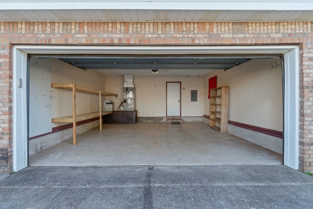 garage featuring electric panel and heating unit