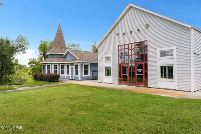 rear view of house featuring a lawn