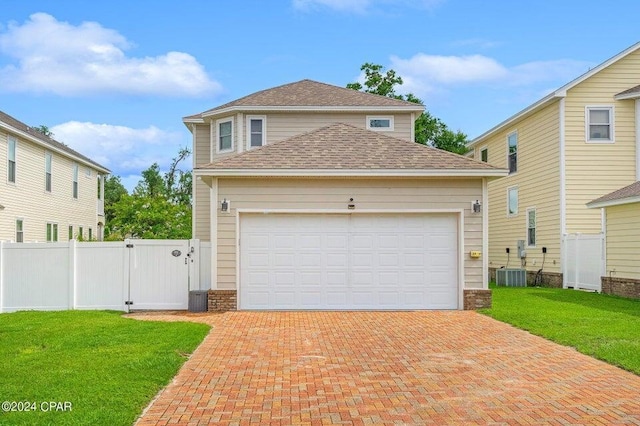 view of front facade featuring a garage, central AC, and a front yard