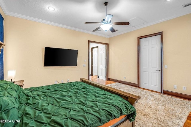 bedroom with ceiling fan and crown molding