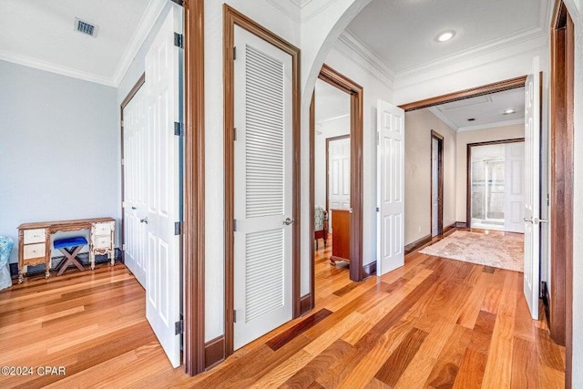 hall featuring light hardwood / wood-style floors and crown molding